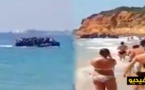 شاهدوا بالفيديو.. قارب للهجرة السرية على متنه العشرات من المهاجرين يفاجئ المصطافين بشاطئ إسباني